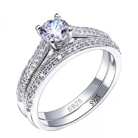 Knife Edge Cathedral Style Engagement Ring Featuring A Round Center Stone and Double Row of Stones on Each Band Plated in White Gold WS035