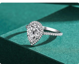 Prong set pave styles side stones and pear halo ring 