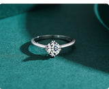 Split prong holding round solitaire center stone with tapered band 