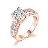 2 Carat Round Split Prong Engagement Ring Featuring Princess Cut Channel Set Side Stones and Round Surprise Stones on Side Profile Rose Gold Eng063