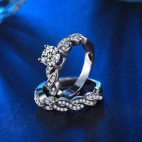 Wedding set round center stones with infinity twist side and side stones