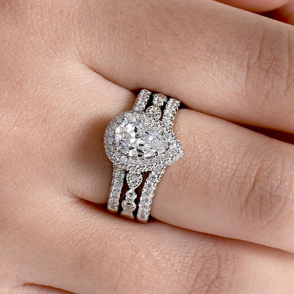 pear shaped engagement ring with halo and matching pave guard band