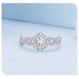Round engagement ring with halo, infinity band and pave side stones 