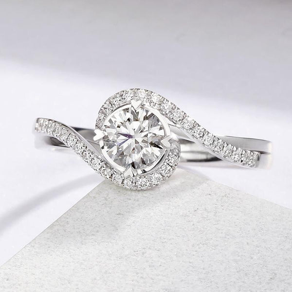 Round bypass engagement ring with side stones pave set