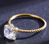 delicate rope solitaire and cushion cut engagement ring