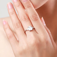 engagement ring emerald cut with two side stones 